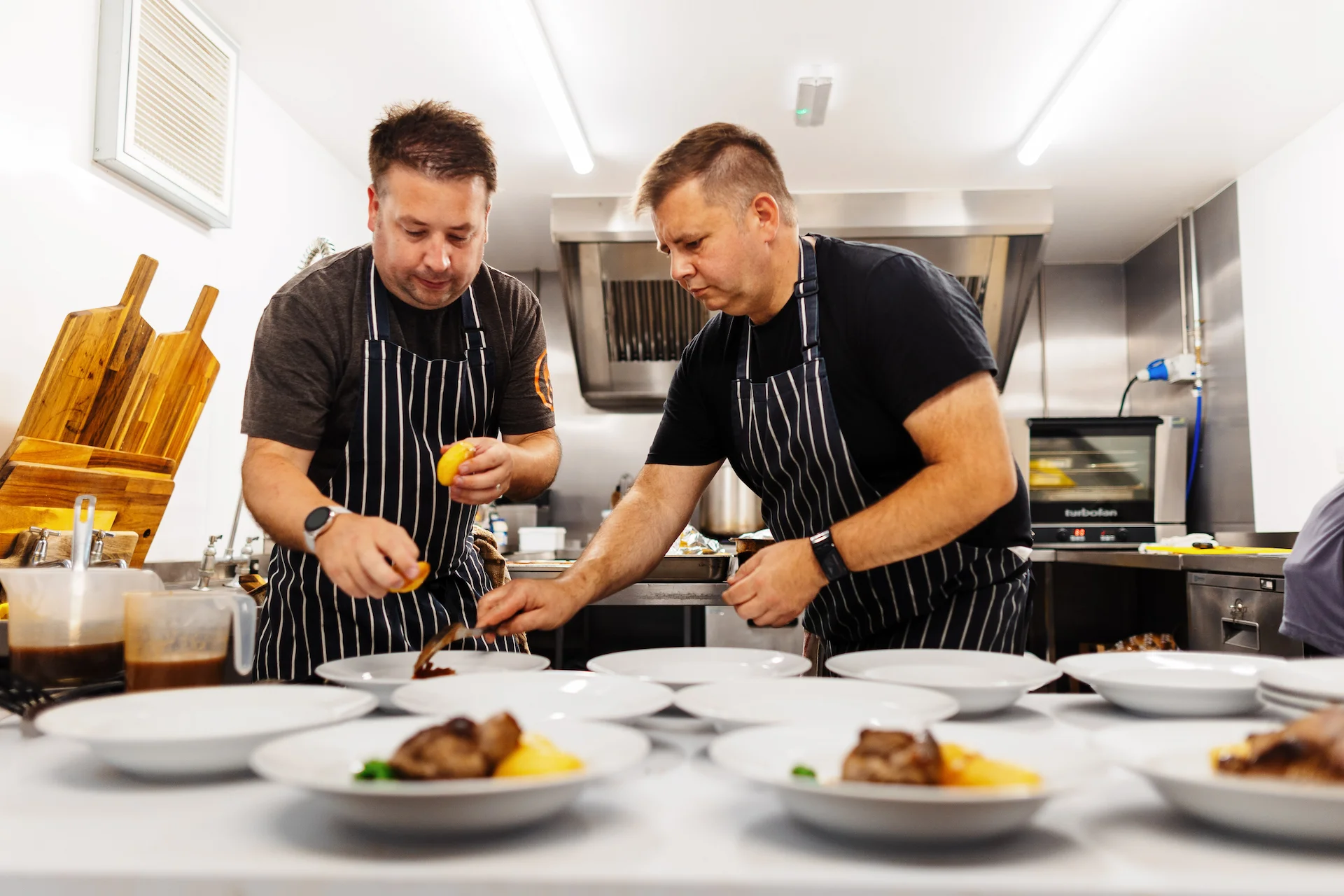 Simon and Dan plating up food